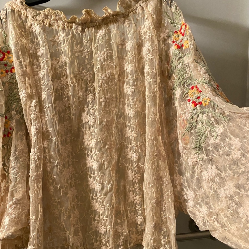 Free people top photo 5 shows a little spot and a tiny hole